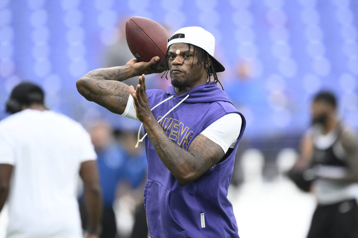 Baltimore Ravens quarterback Lamar Jackson (8) works out before a preseason NFL football game a ...