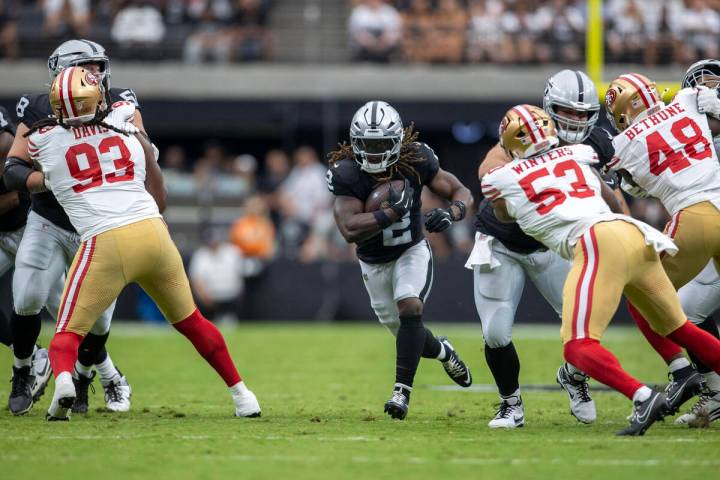 Raiders running back Ashton Jeanty (2) breaks through a gap in the San Francisco 49ers defense ...