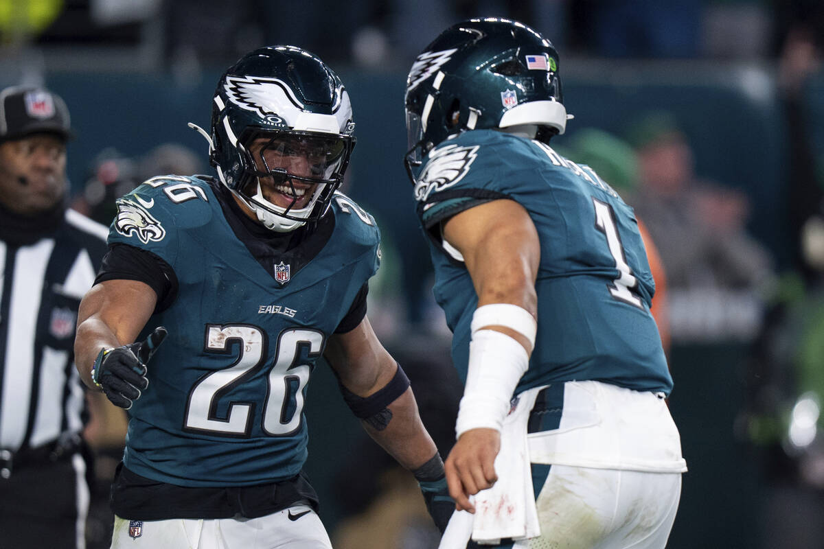 Philadelphia Eagles running back Saquon Barkley (26) reacts to the touchdown with quarterback J ...