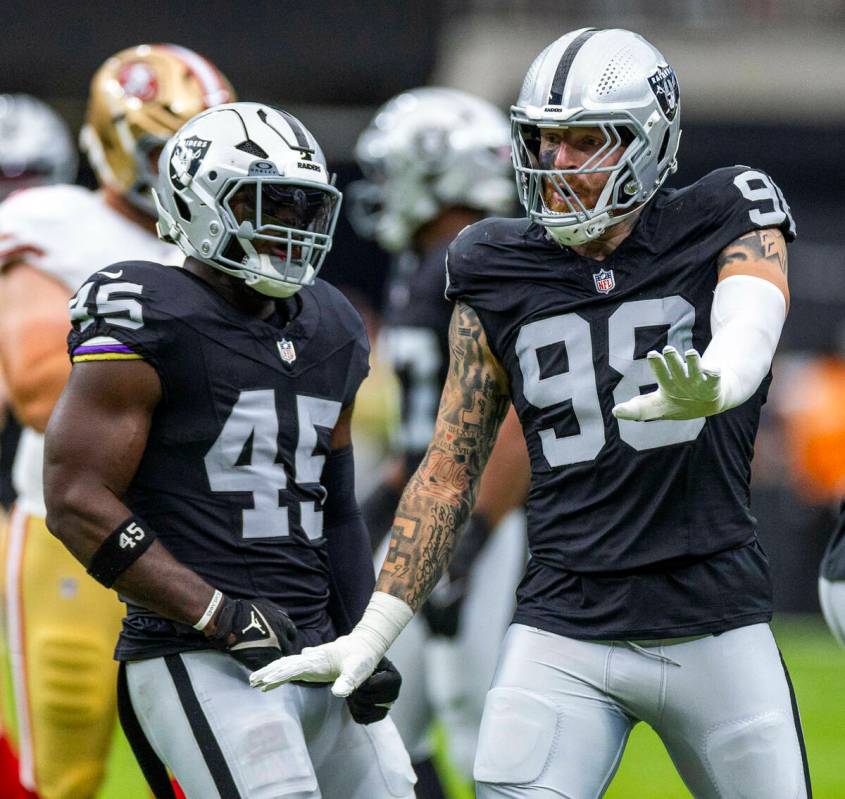 Raiders linebacker Devin White (45) celebrates a stop with defensive end Maxx Crosby (98) on Sa ...