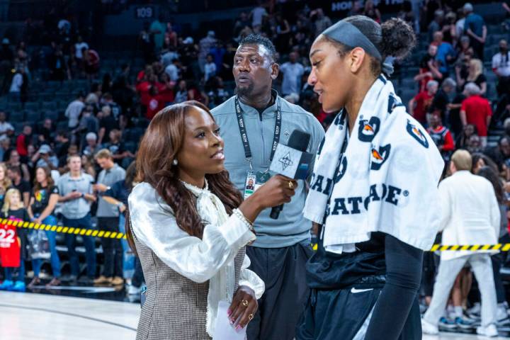 Las Vegas Aces security director Sonny Watson keeps a watch on the crowd as Aces center A'ja Wi ...