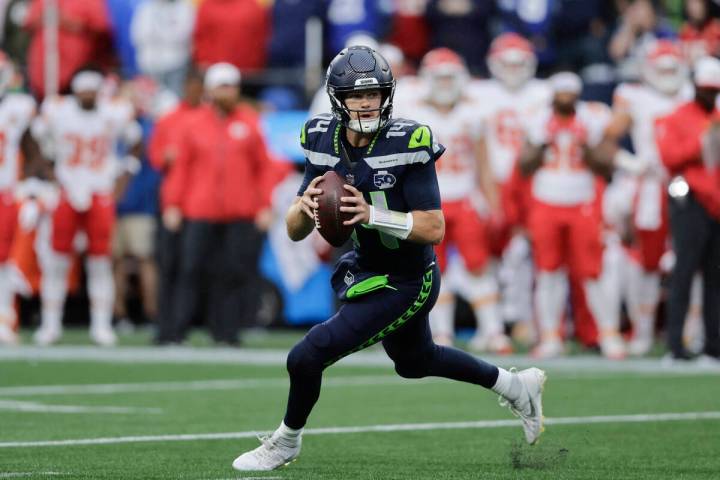 Seattle Seahawks quarterback Sam Darnold (14) looks to pass during the first half of an NFL pre ...