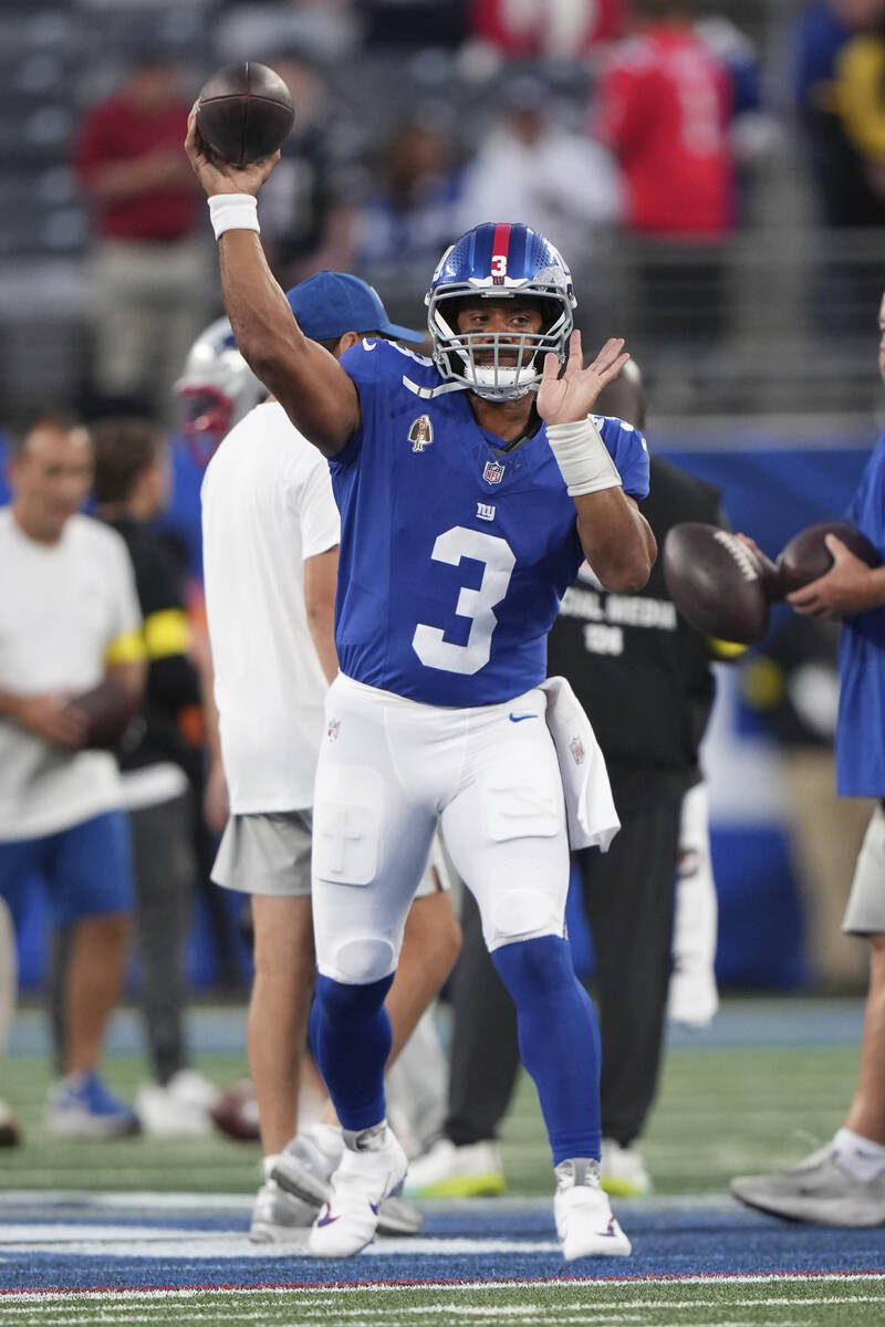 New York Giants quarterback Russell Wilson (3) warms up before an NFL preseason football game a ...