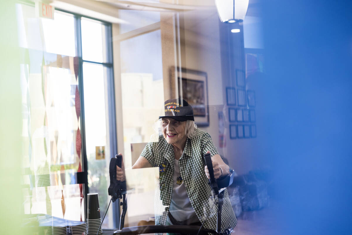 Henderson resident Lorraine Demarest walks into her 100th birthday celebration at Christ the Se ...