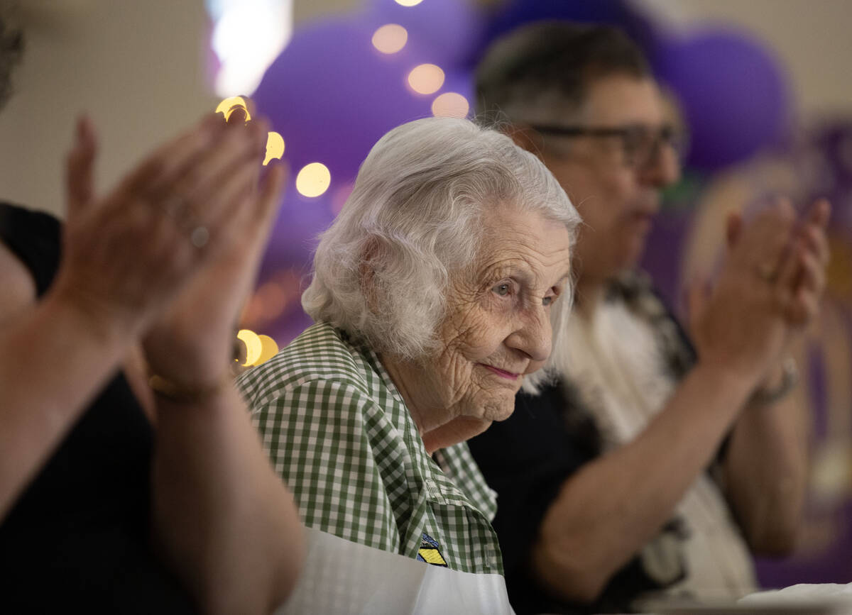 Henderson resident Lorraine Demarest reacts to applause during her 100th birthday celebration ...