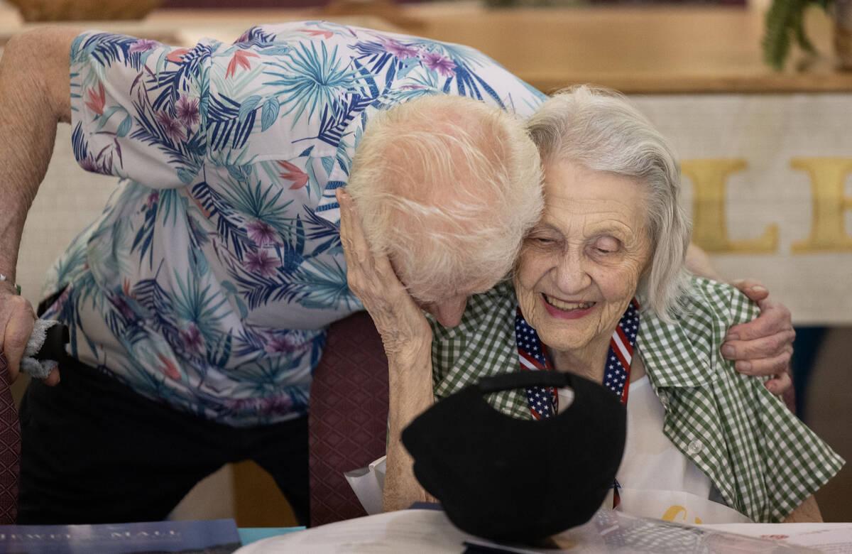Henderson resident Lorraine Demarest hugs Bruce Lunquist at the end of her 100th birthday celeb ...