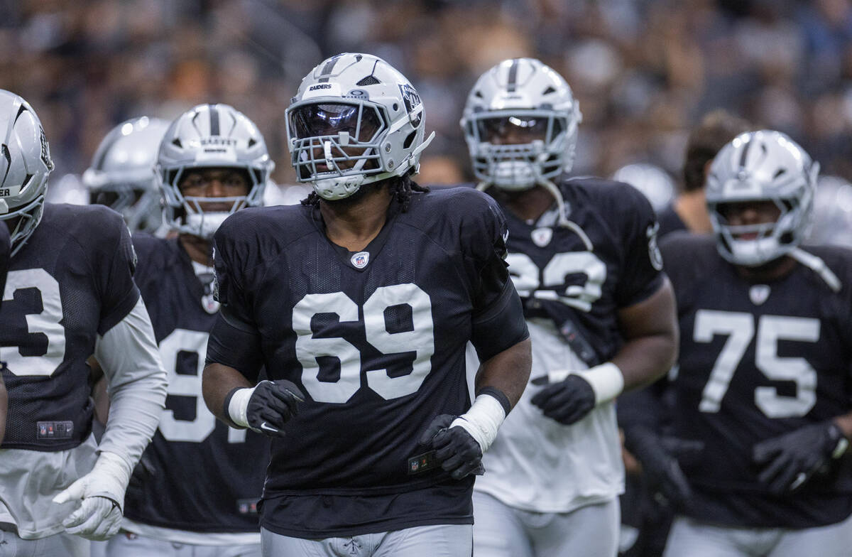Raiders defensive tackle Adam Butler (69) and teammates take the field during the first half of ...