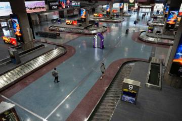 People walk through Harry Reid International Airport, Friday, Aug. 29, 2025, in Las Vegas. (AP ...
