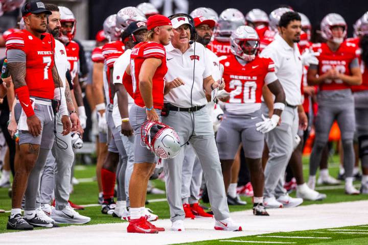 UNLV quarterback Anthony Colandrea (10) listens to head coach Dan Mullen as they talk on the si ...
