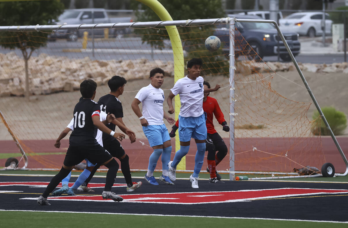Canyon Springs players get the ball away from the goal during a soccer game at Las Vegas High S ...