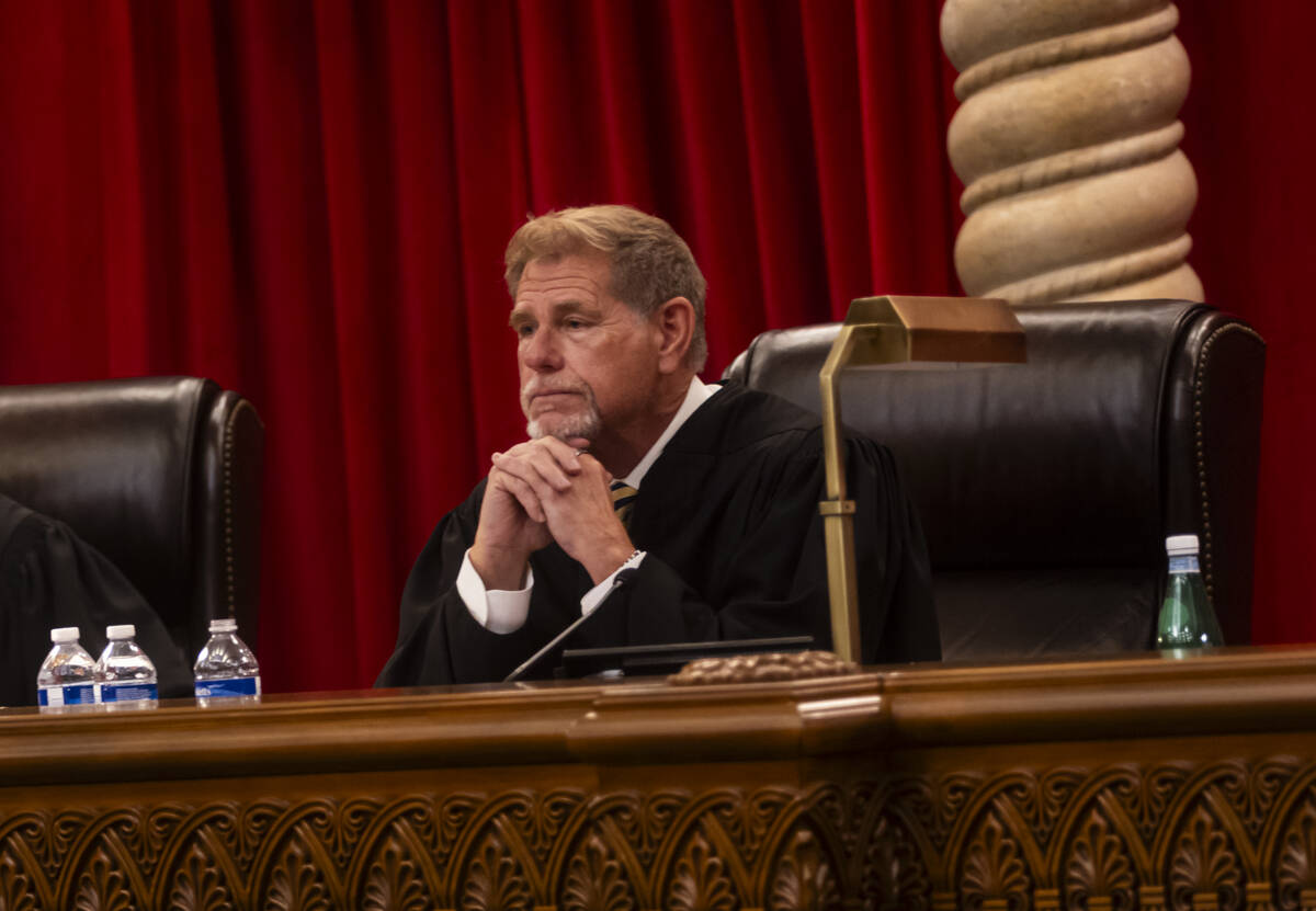 Nevada Supreme Court Justice Ron Parraguirre listens to J. Gregory Cloward, representing Nevada ...
