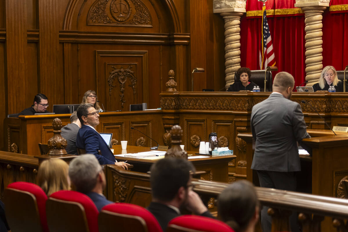Attorney Paul Taggart, left, representing Pure Energy, looks on during oral arguments, in a cas ...