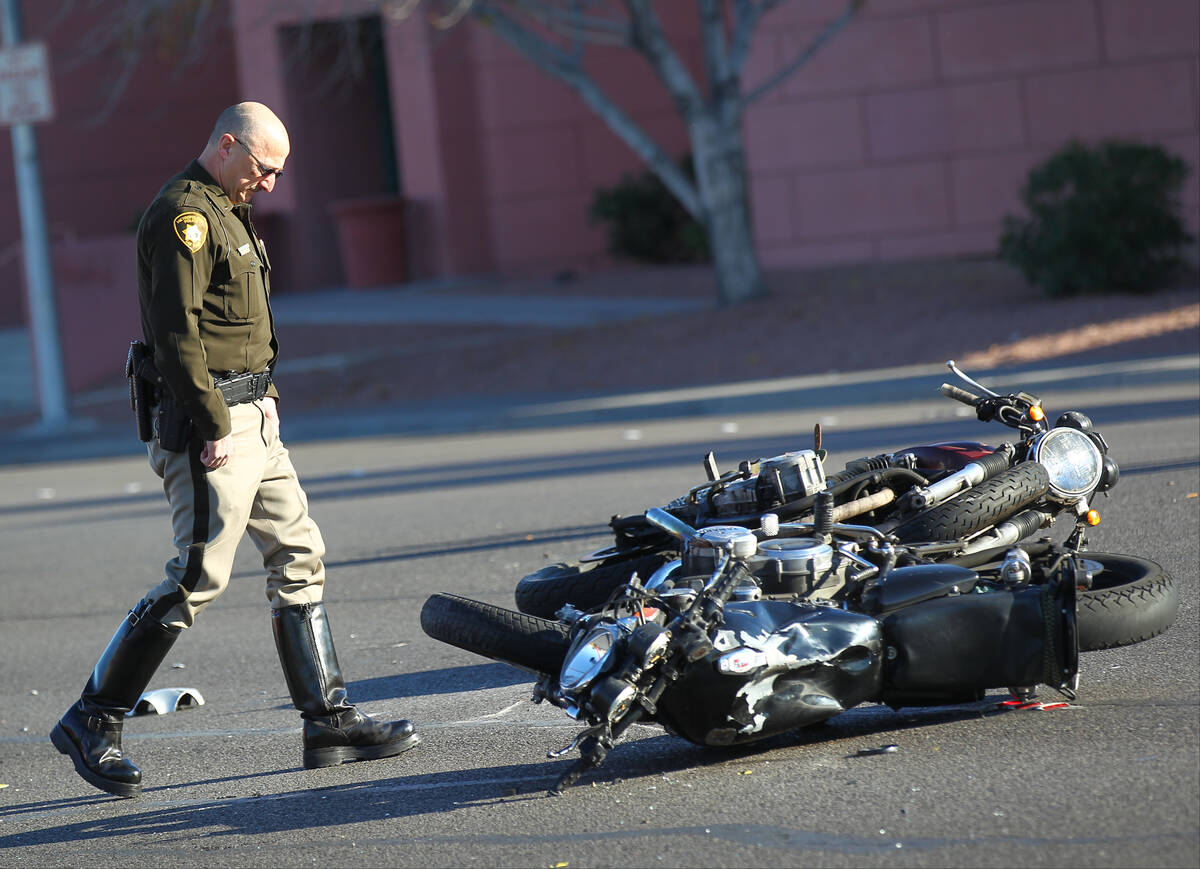 Las Vegas police investigate the scene of a crash involving two motorcycles and one car on Flam ...