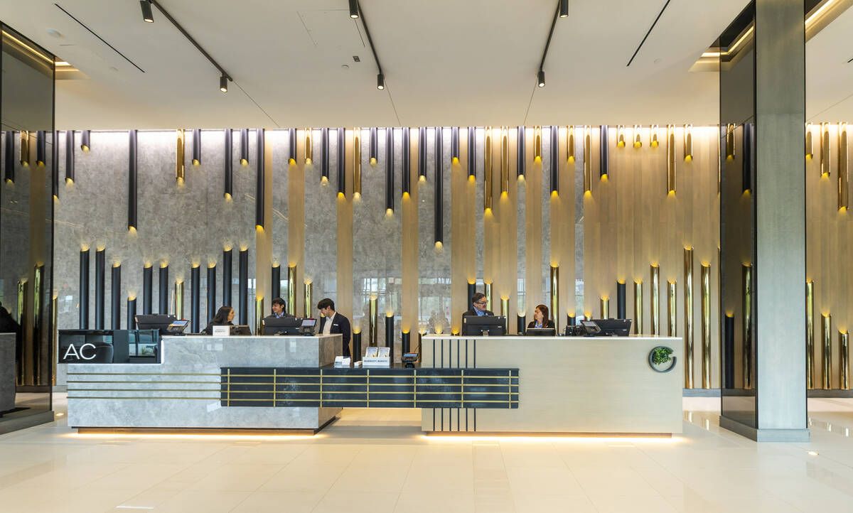 Staff work about the front desk and main lobby of the new AC / Element Hotel Symphony Park on T ...
