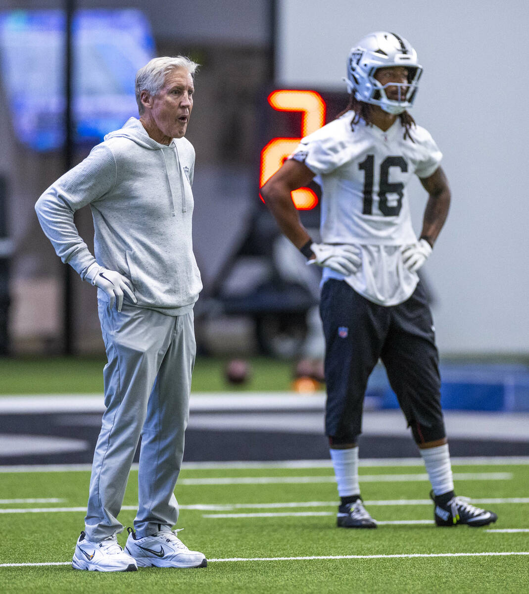 Raiders head coach Pete Carroll and Raiders wide receiver Jakobi Meyers (16) await another punt ...