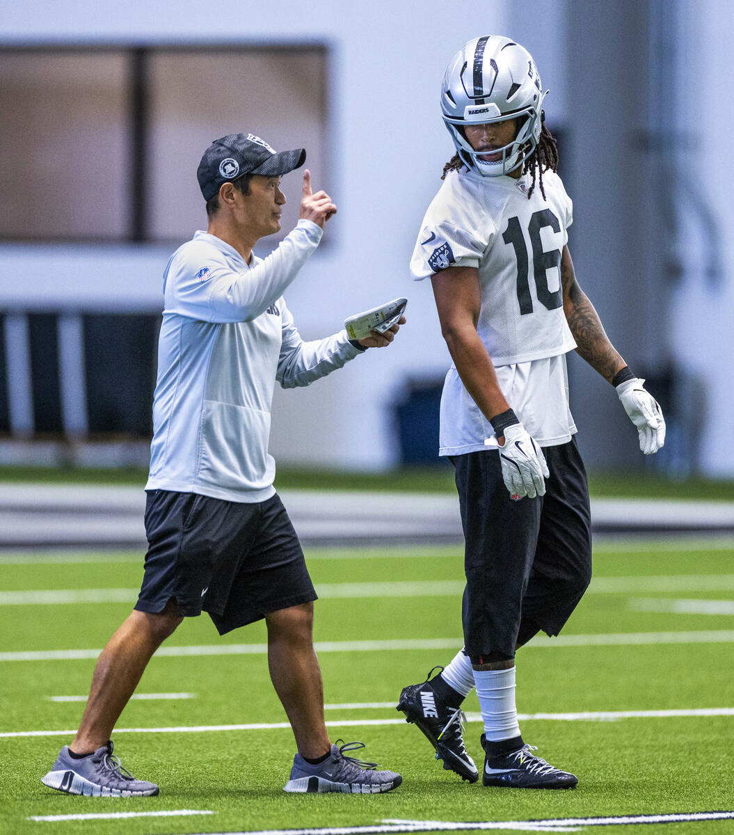 Raiders assistant special teams coach Kade Rannings works with wide receiver Jakobi Meyers (16) ...