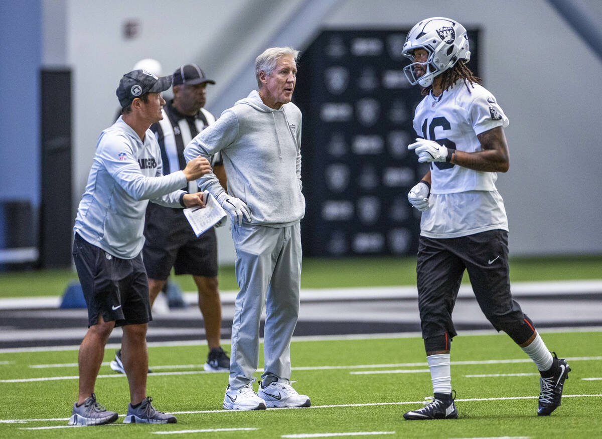 Raiders head coach Pete Carroll looks to wide receiver Jakobi Meyers (16) as he talks with assi ...