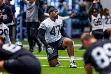 Raiders defensive tackle Thomas Booker IV (47) stretches with teammates during training camp in ...