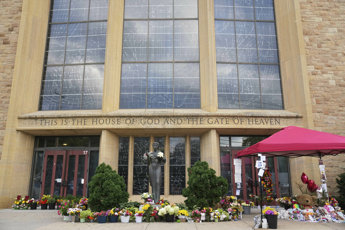 Items line a memorial at Annunciation Catholic Church after Wednesday's school shooting, T ...