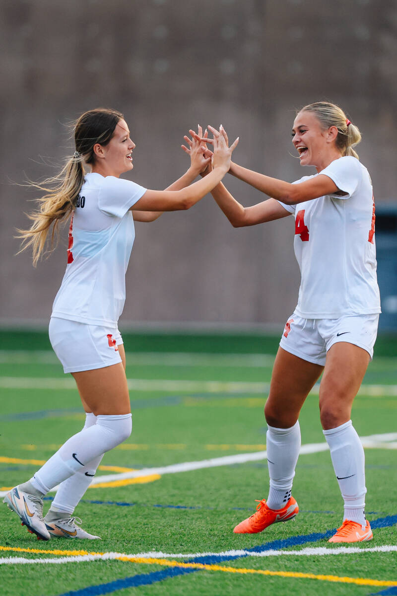 Coronado defender Ella Schultz high-fives teammate Allison Kleiner after a goal during a girls ...