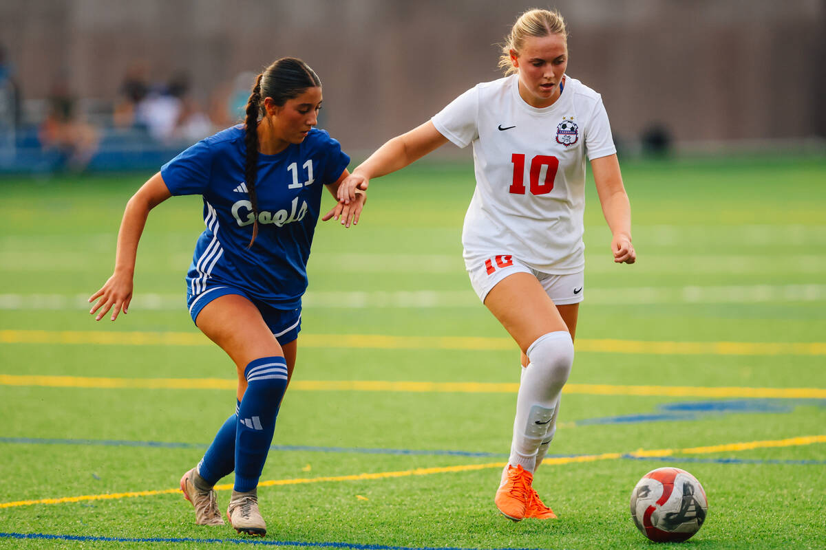 Bishop Gorman midfielder Devyn Giraldo (11) and Coronado midfielder Ryan Neel chase the ball du ...