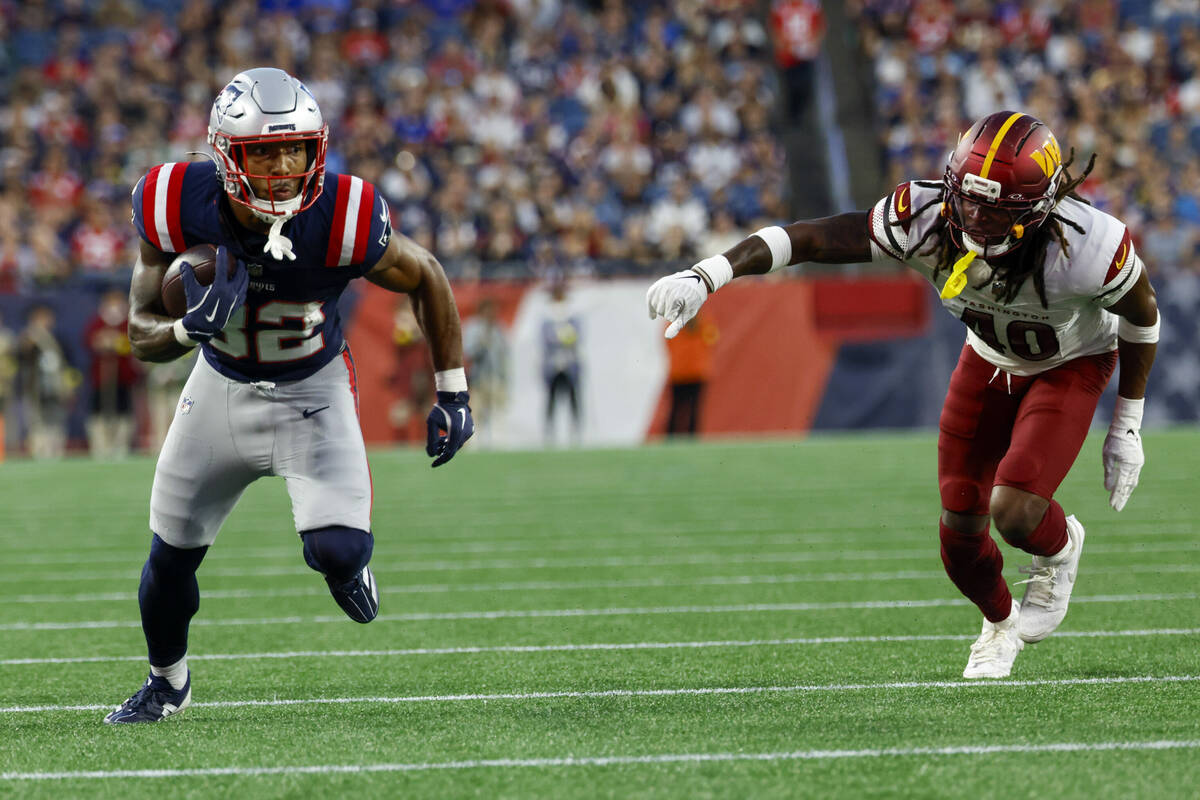 New England Patriots running back TreVeyon Henderson (32) evades Washington Commanders safety T ...