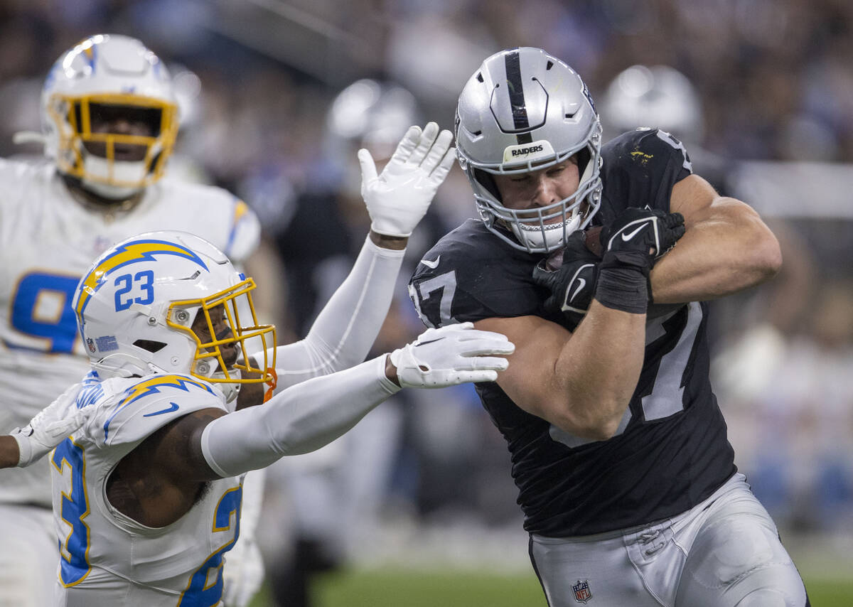 Los Angeles Chargers safety Tony Jefferson (23) tries to defend as Raiders tight end Michael Ma ...