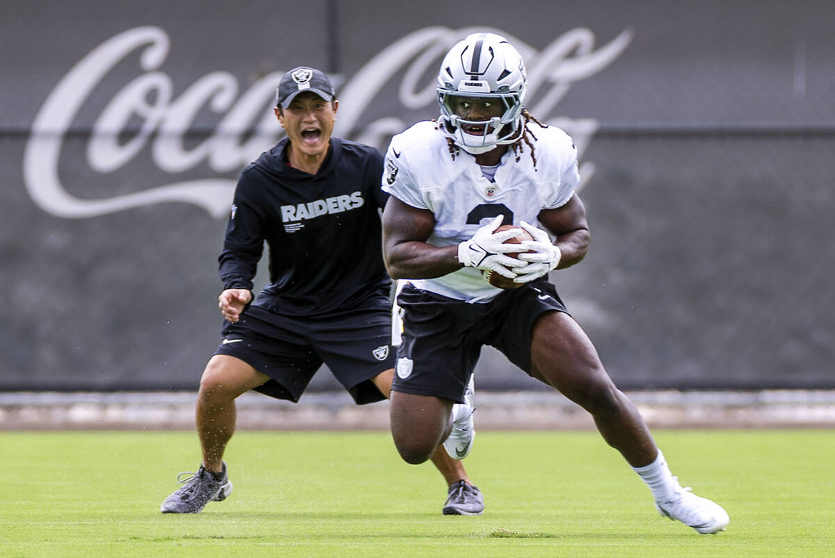 Raiders running back Ashton Jeanty (2) returns a punt as assistant special teams coach Kade Ran ...