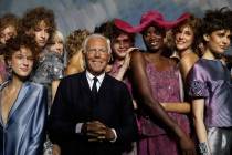 FILE - Designer Giorgio Armani, centre, poses with models at the end of his women's 2019 S ...