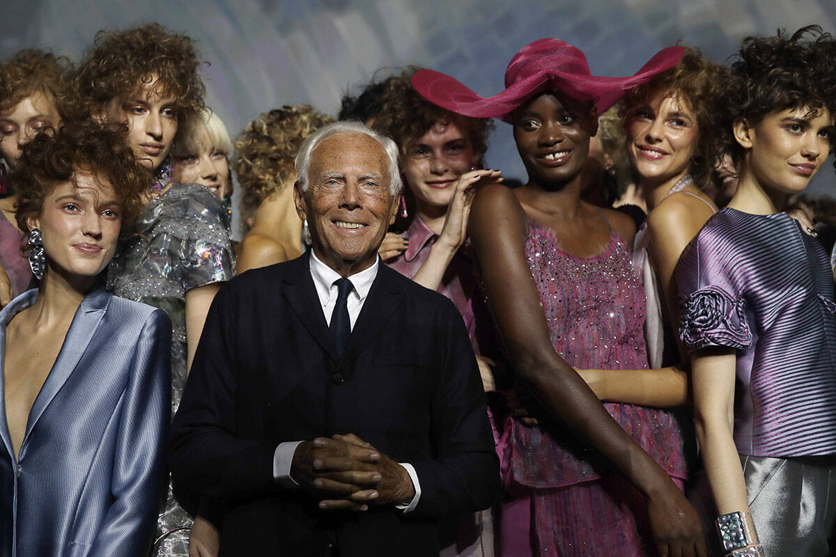 FILE - Designer Giorgio Armani, centre, poses with models at the end of his women's 2019 S ...