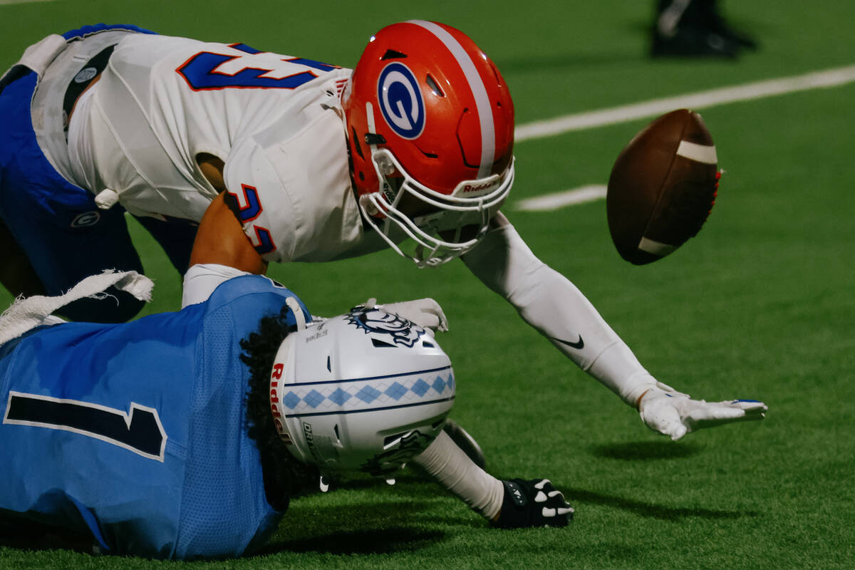 Bishop Gorman defensive back Justin Colin (23) breaks up a pass intended for Centennial wide re ...