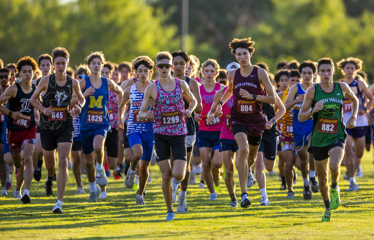 Varsity A Boys competitors merge into a tighter formation away from the start line during the 5 ...