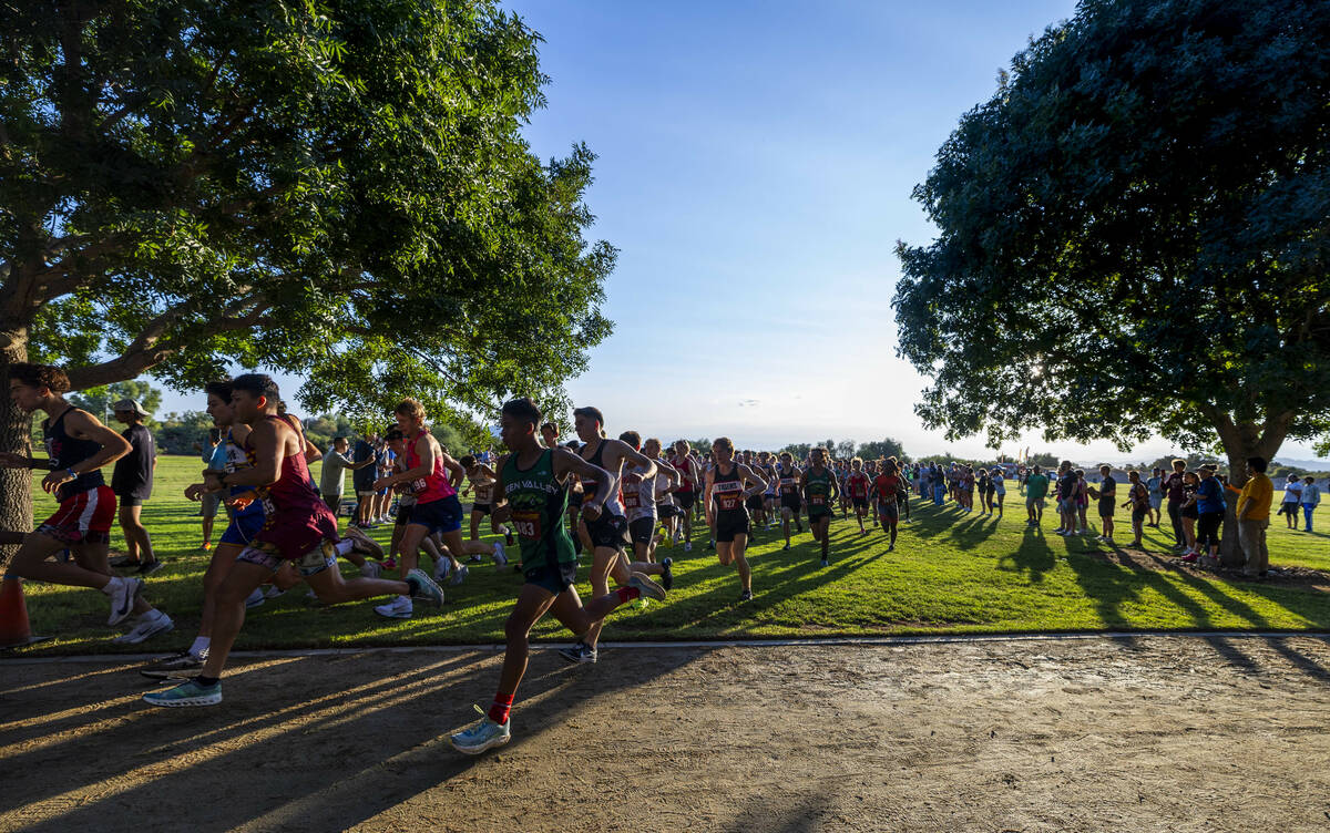 Varsity A Boys competitors merge into a tighter formation at the make the first turn during the ...