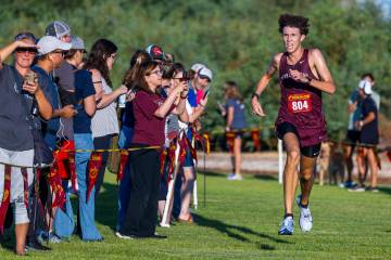 Faith Lutheran High School runner Brady Anderson (804) nears the finish to take first place in ...