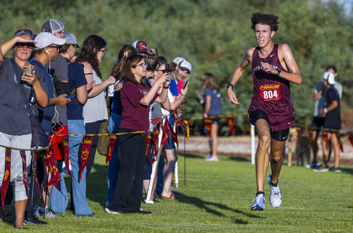 Faith Lutheran High School runner Brady Anderson (804) nears the finish to take first place in ...