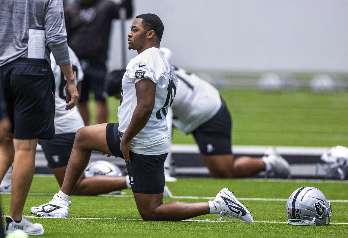 Raiders wide receiver Amari Cooper (19) stretches with teammates during practice at the Intermo ...