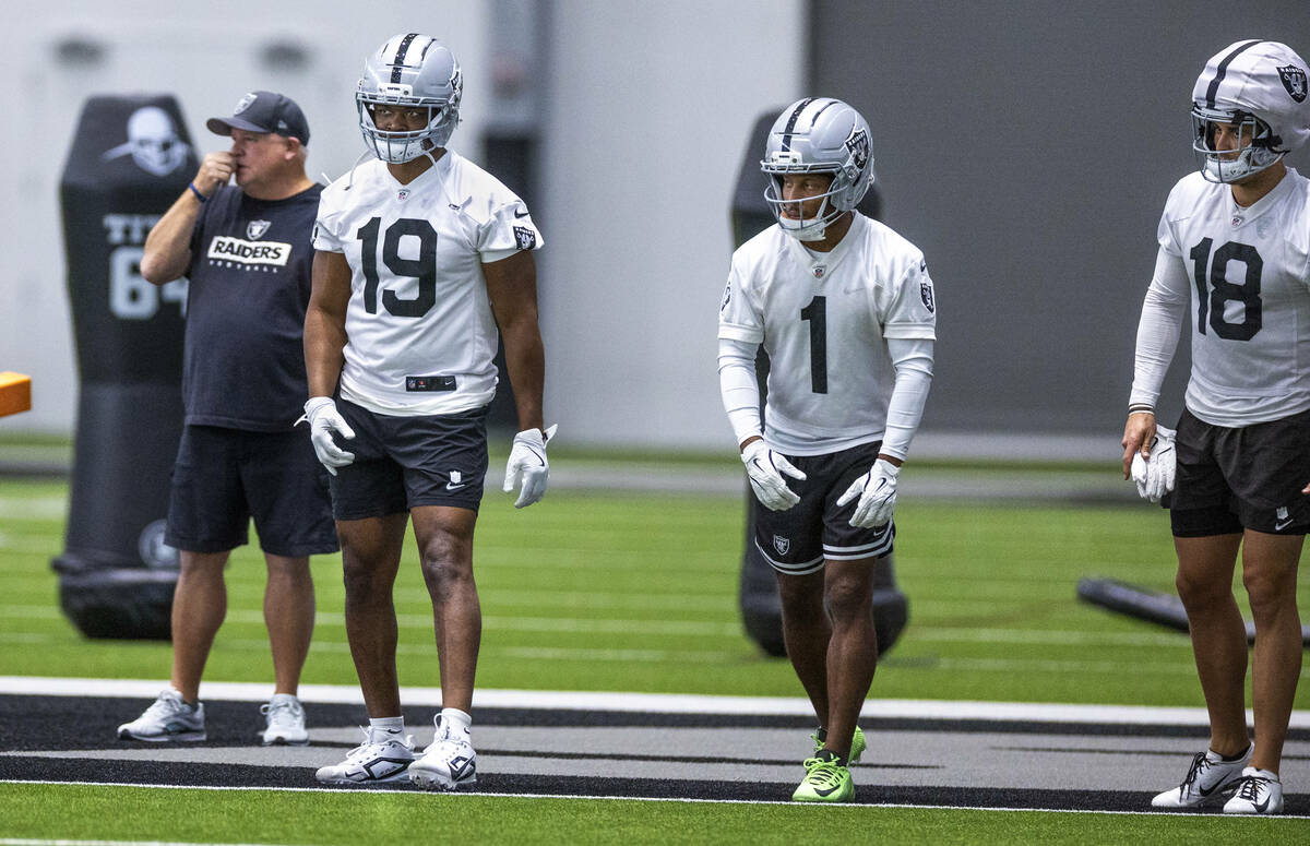Raiders wide receivers Amari Cooper (19), Tre Tucker (1) and Jack Bech (18) wait to run sprints ...