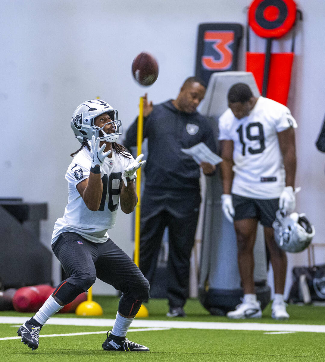 Raiders wide receiver Jakobi Meyers (16) looks in a punt as wide receiver Amari Cooper (19) tal ...