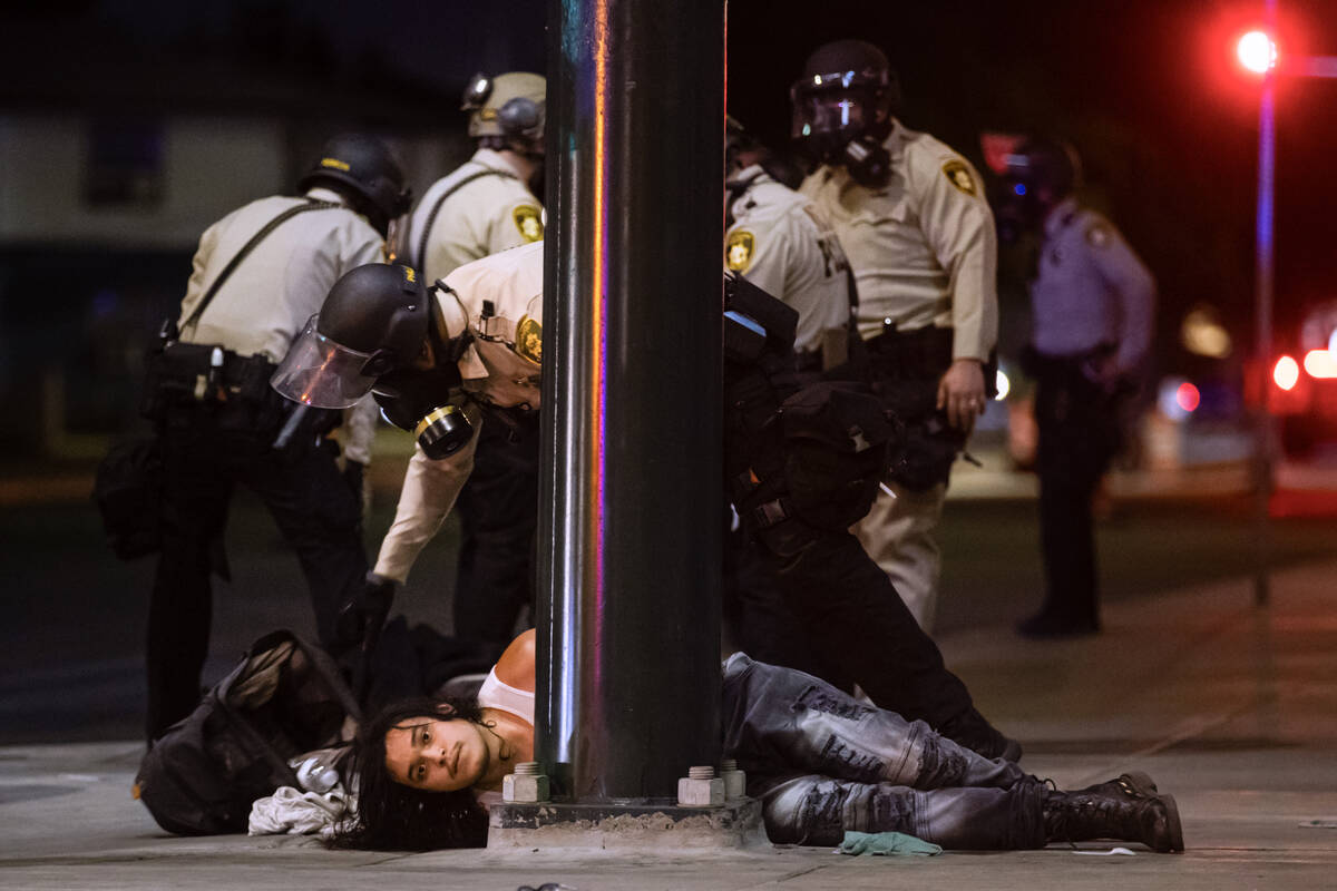 Las Vegas police officers detain people protesting against ICE at Fremont Street and Maryland P ...