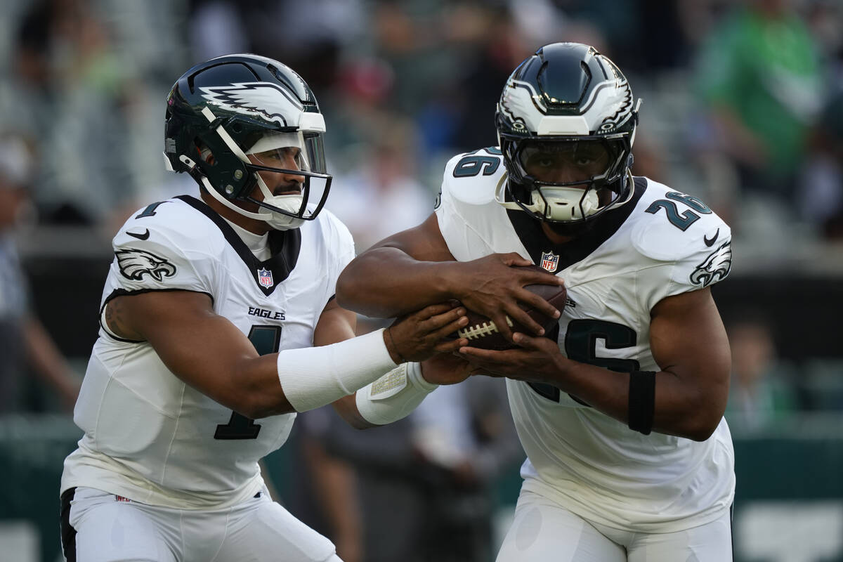 Philadelphia Eagles' Jalen Hurts and Saquon Barkley warm up before an NFL preseason footba ...
