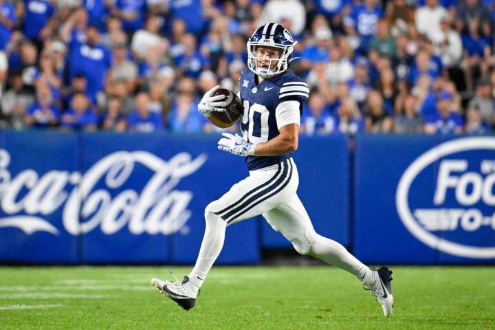 Brigham Young Cougars cornerback Cannon DeVries (20) runs the football during the second half o ...