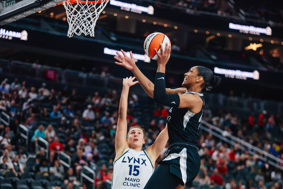 Aces center A'ja Wilson (22) puts up a shot as Minnesota Lynx forward Jessica Shepard (15) ...