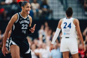 Aces center A'ja Wilson celebrates a three point shot during a WNBA basketball game betwee ...