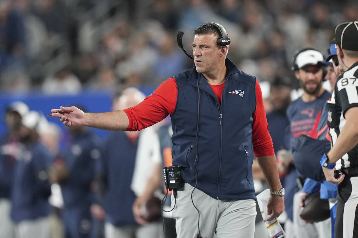 New England Patriots head coach Mike Vrabel talks to an official during an NFL preseason footba ...