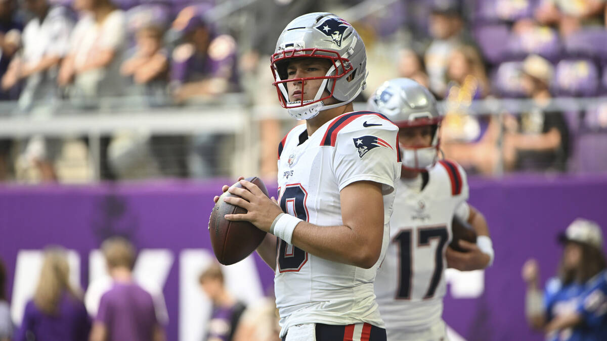 New England Patriots quarterback Drake Maye (10) warms up before their game against the Minneso ...