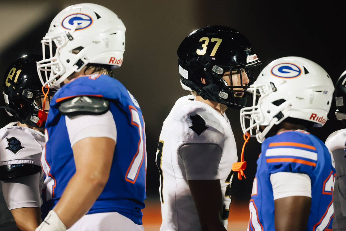 Players shake hands during a line up after Lone Peak was forced a forfeit a high school footbal ...