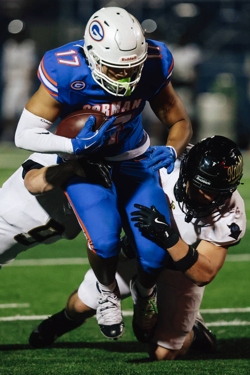 Bishop Gorman wide receiver Trent Walker (17) carries the ball through Lone Peak defense during ...