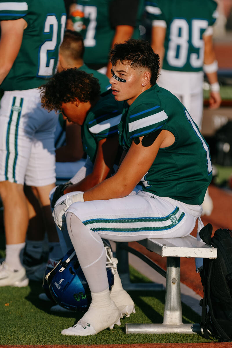 Green Valley wide receiver/defensive back Roman Adams (11) sits on the bench after just coming ...