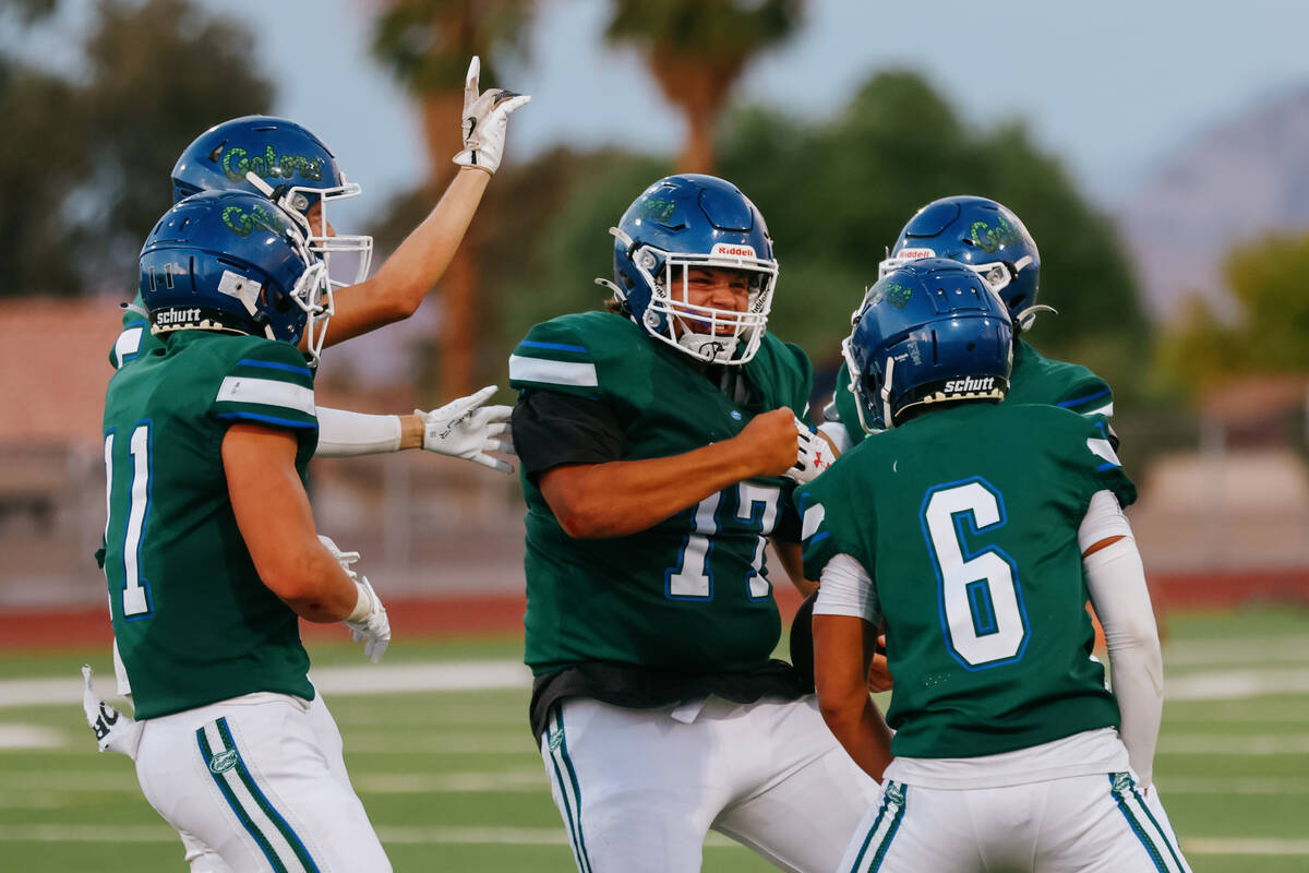 Green Valley defensive tackle Clayton Floyd (77), center, celebrates with teammates after inter ...