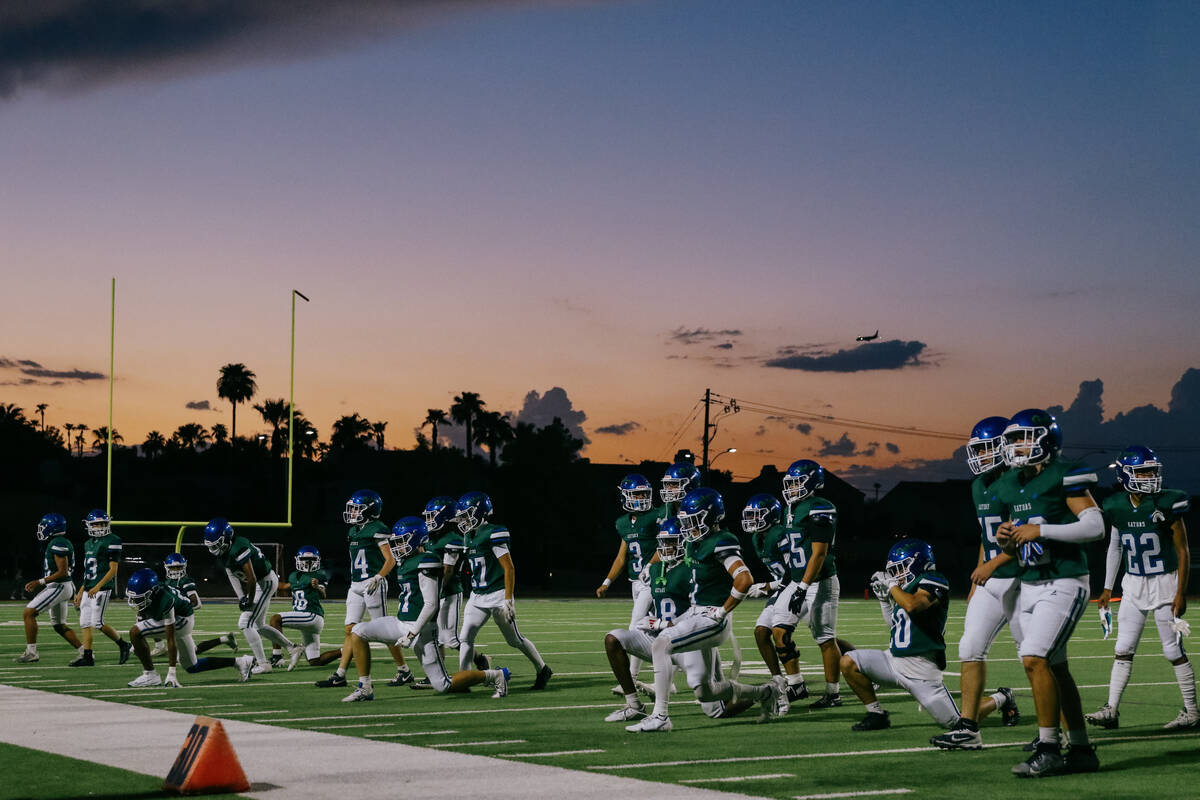 Green Valley players warm up to prepare for the third quarter of the football game against Palo ...